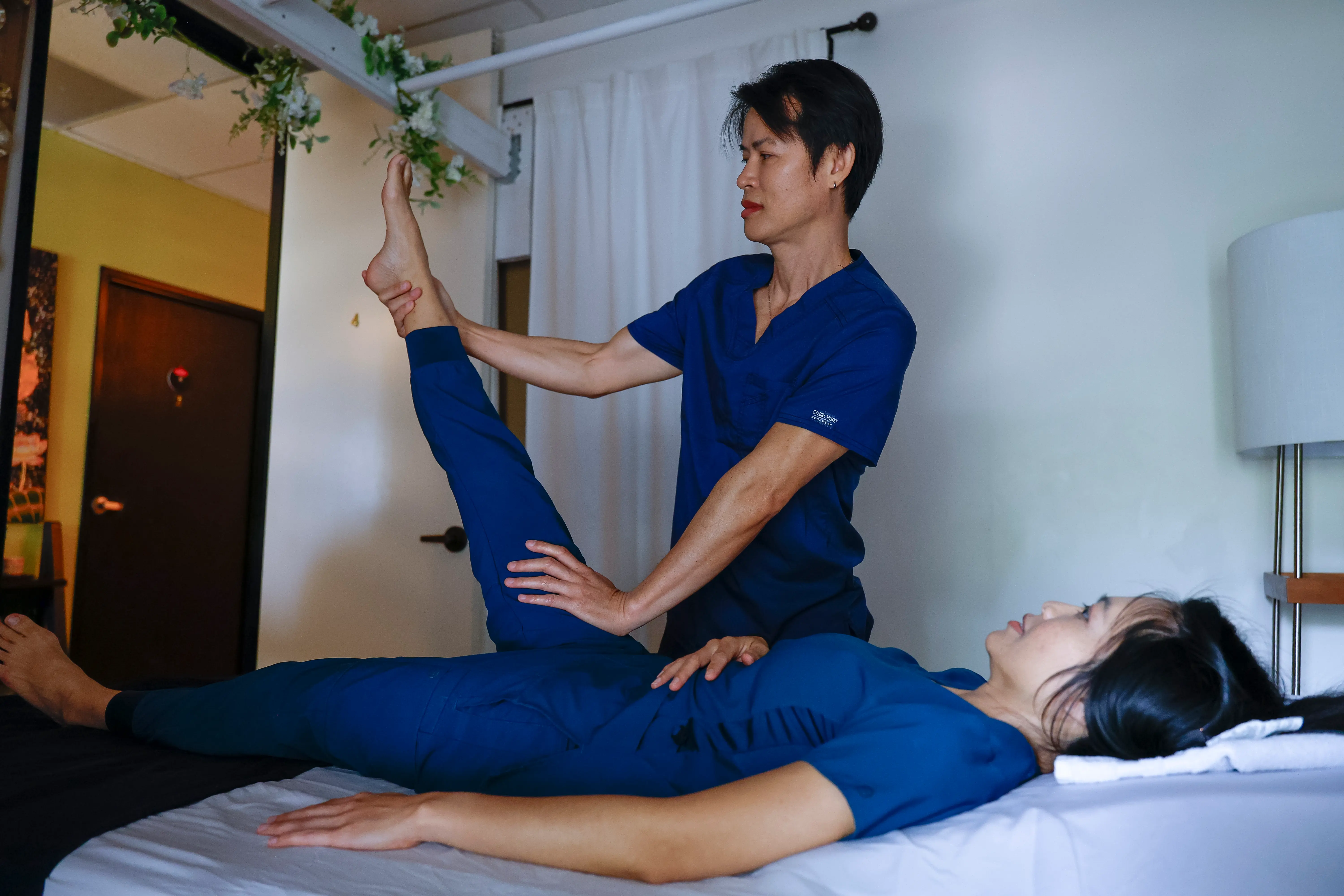Assisted stretching during a traditional Thai massage