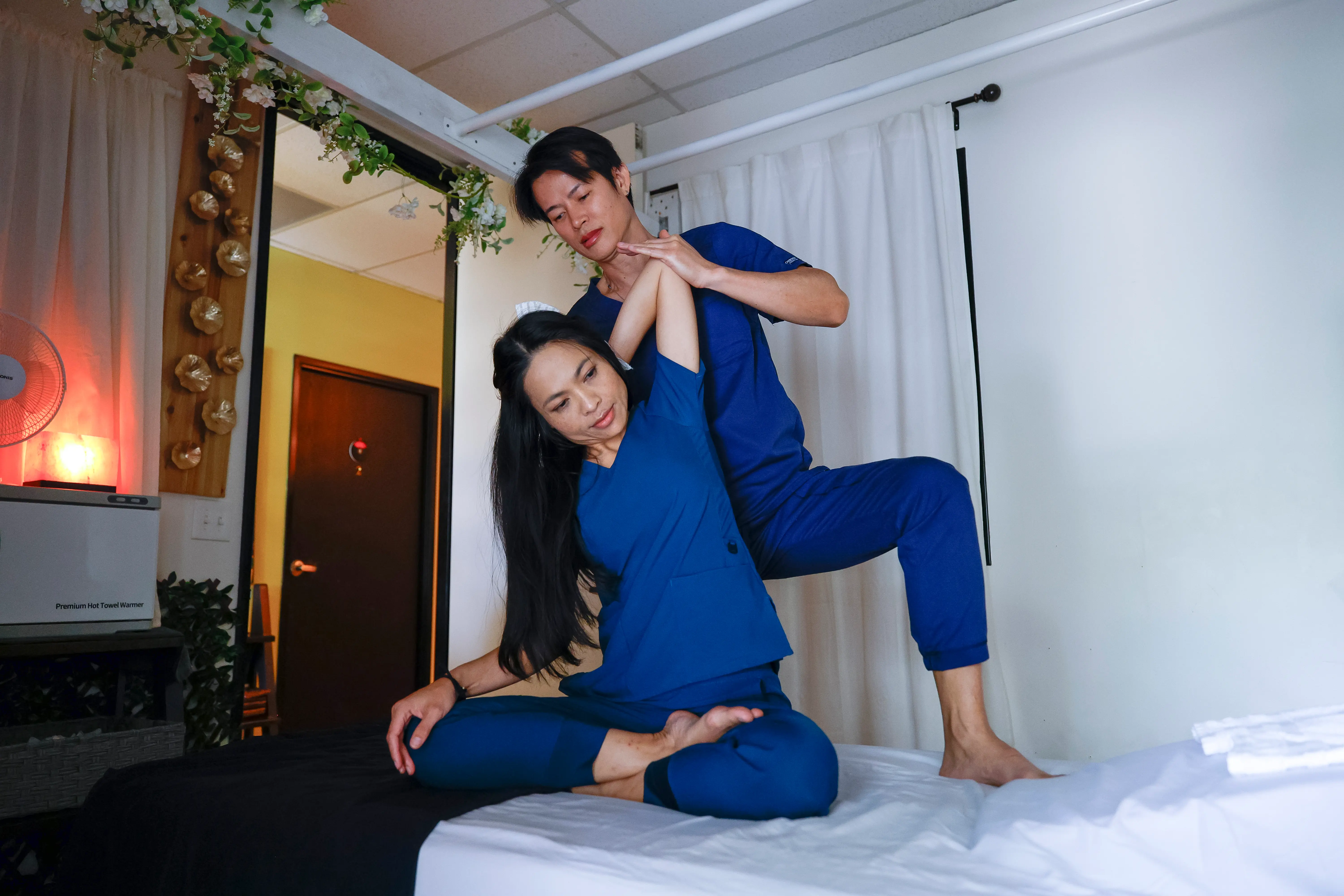 Therapist performing traditional Thai massage techniques